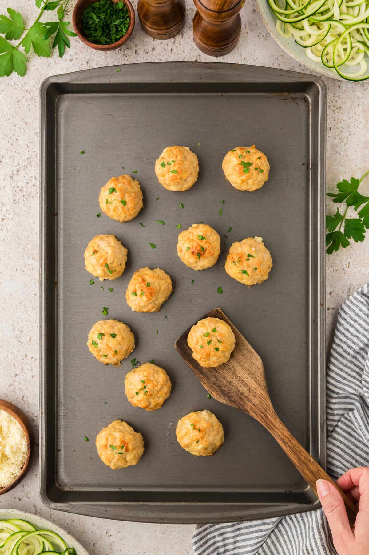 Baked keto chicken meatballs on sheet pan.