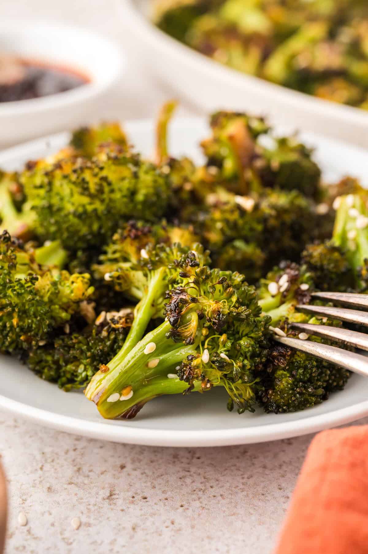 Plate full of Asian roasted broccoli.