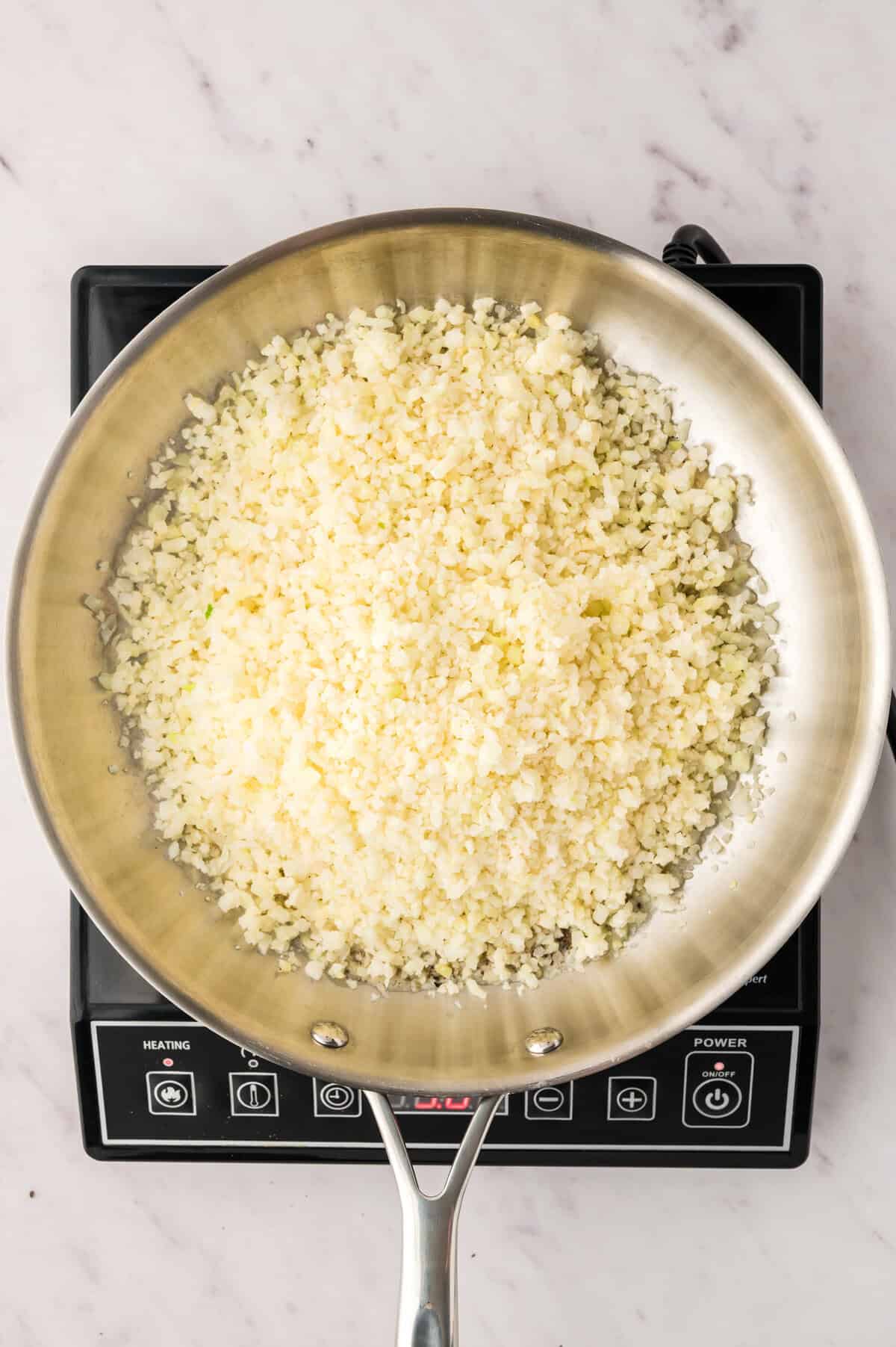 Cauliflower rice in skillet.