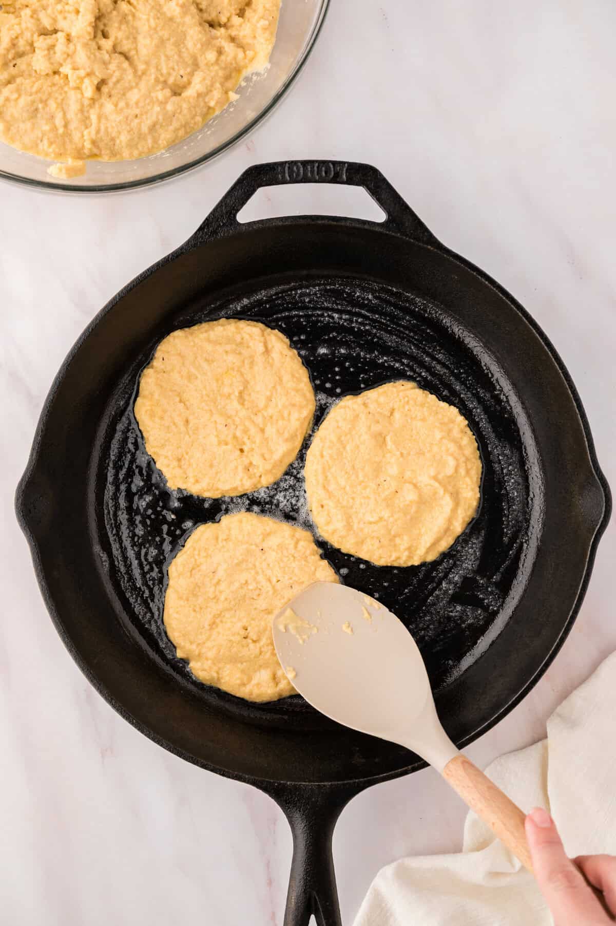 Almond flour pancakes in a cast iron skillet.