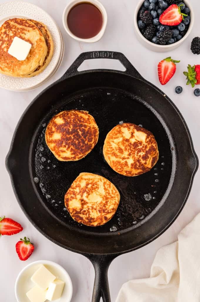 Almond flour pancakes in cast iron skillet.