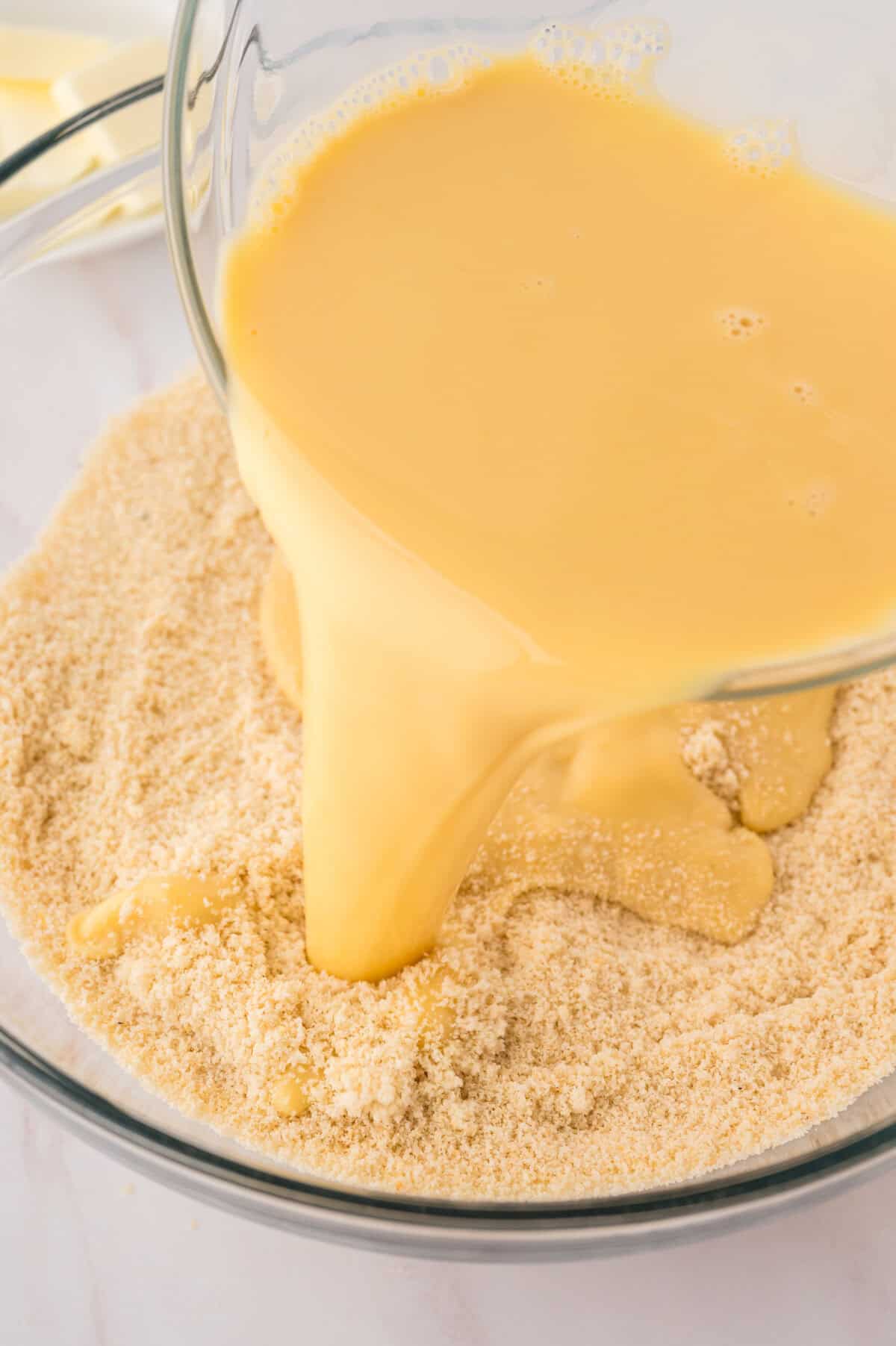 Wet ingredients being poured into dry ingredients.