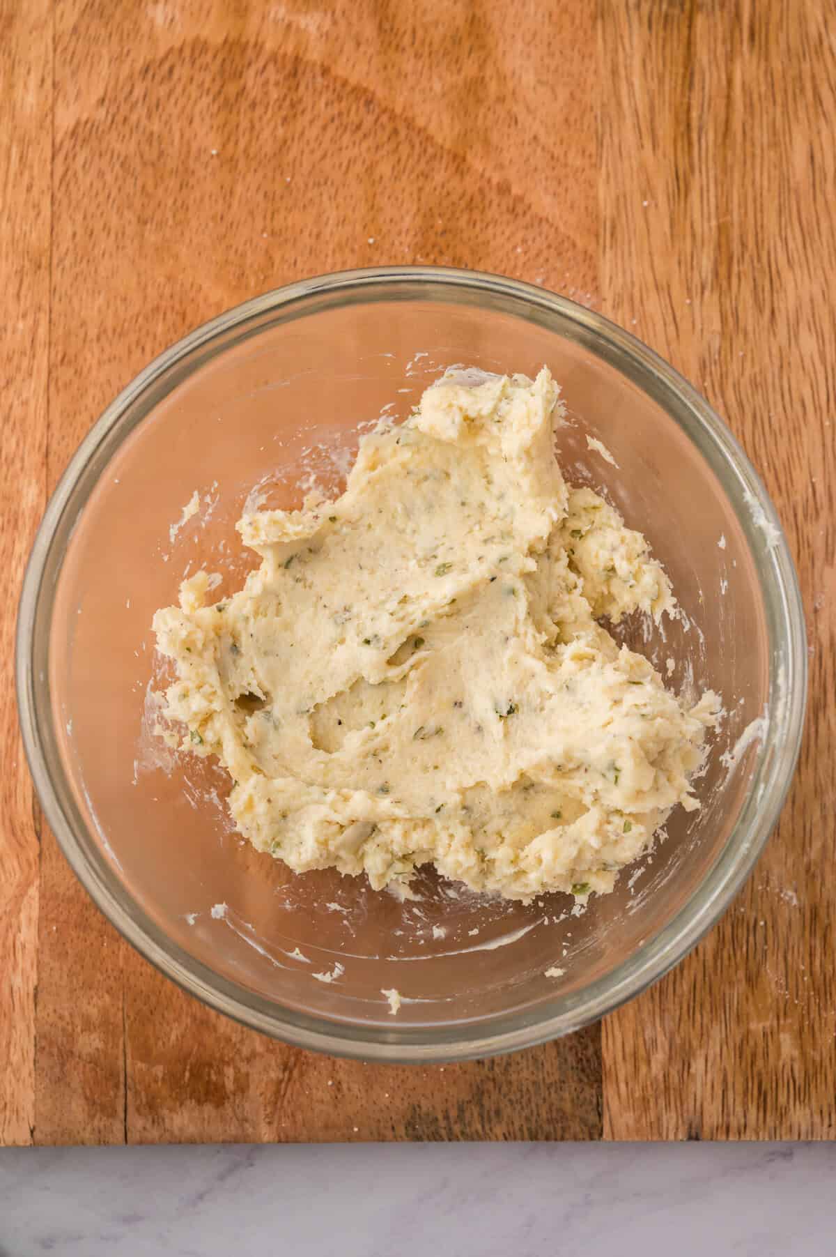Ranch seasoning and cream cheese mixed together in a bowl.