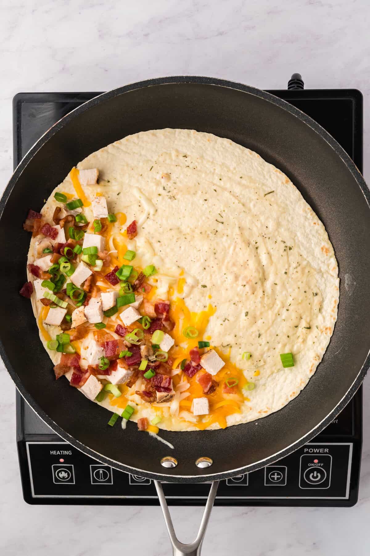 Chicken, bacon, and cheese in a tortilla.