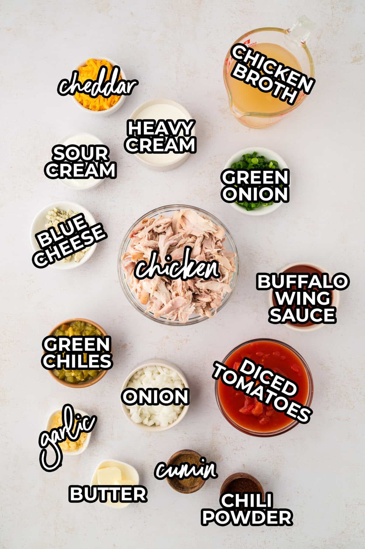 Keto buffalo chicken soup ingredients laid out on countertop.