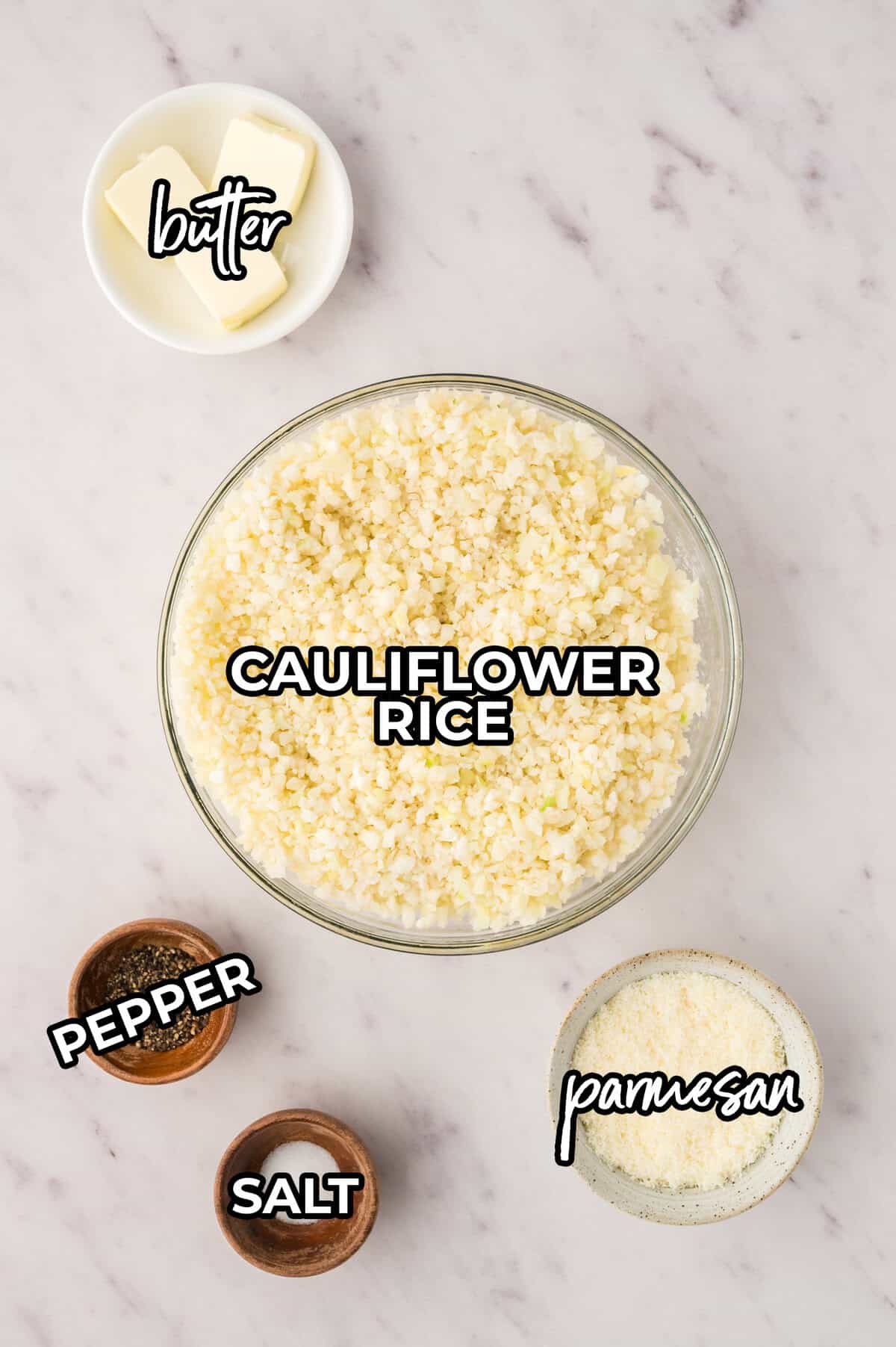 Ingredients for cacio e pepe cauliflower rice laid out on counter.