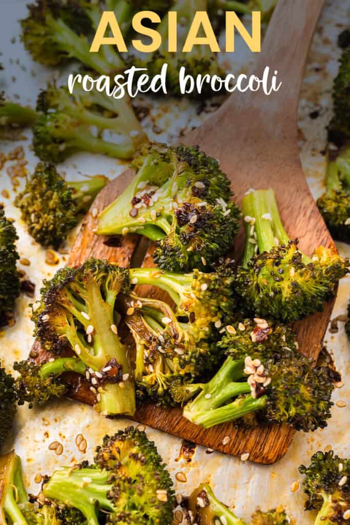 Roasted broccoli on sheet pan with spatula.